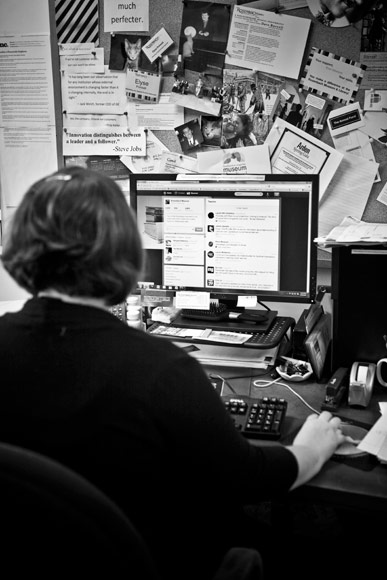 Elyse Poinsett working the soical media channels from her desk