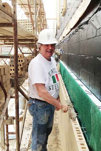 Tom Celli, who first trained as a bricklayer, working on Mt. Lebanon High school