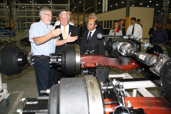 Governor Tom Corbett, center, with Carlos Cardoso, right, and a worker at Westport Axle