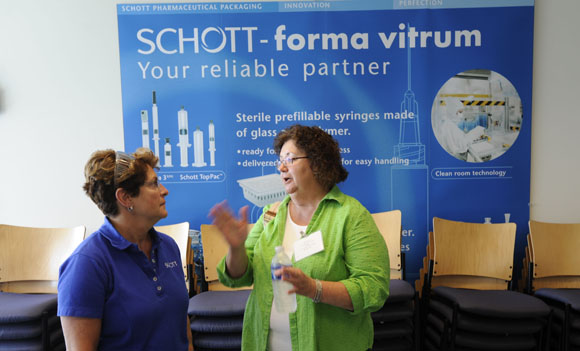 Human Resources Generalist Joyce Peaster, left , speaks with visitor Betty Isaacson.
