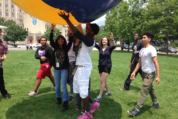Students playing with a giant ball in Schenley Plaza as part of a lesson with City of Play