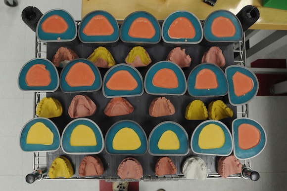 A tray of rubber molds wait for plaster castings